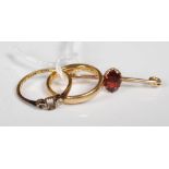 An 18ct gold wedding ring, together with a part yellow metal ring and a yellow metal and garnet