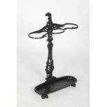 Late 19th/ early 20th century cast iron umbrella stand, the scrolling three compartment top on a