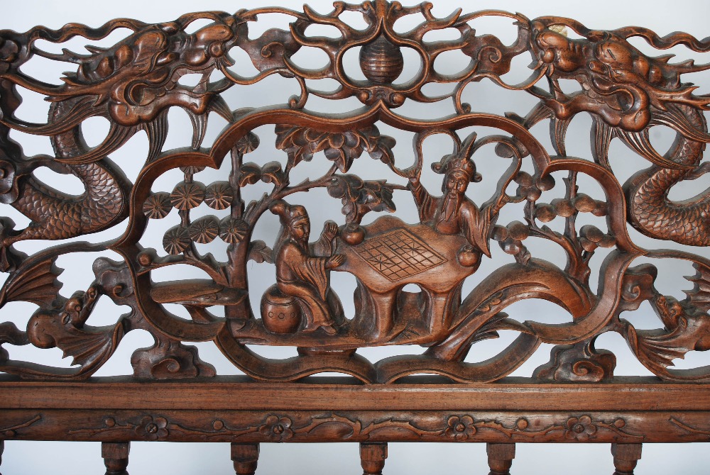 A Chinese carved darkwood bench, Qing Dynasty, the back richly carved in relief with two dragons - Image 4 of 8