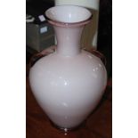 A 20th century pink ground glass vase, of baluster form with flared neck and two applied handle