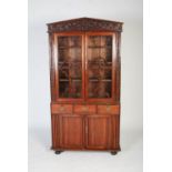 A 19th century Chinese carved darkwood bookcase, the pointed pediment carved in relief with