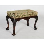 A George II and later walnut stool, the square cabriole legs carved with scalloped detail and the