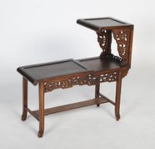A Chinese carved darkwood low display stand / table, Republic period, an asymmetric arrangement of