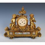 A 19th century Continental gilt metal and porcelain mounted mantel clock, the circular dial with