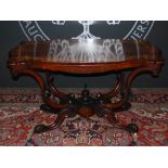 A Victorian walnut and marquetry inlaid centre table, the shaped rectangular top with serpentine