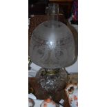 Late 19th/ early 20th century crystal based oil lamp, with brass fitting, an acid etched glass shade