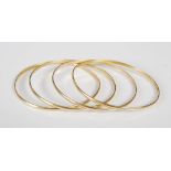 A set of four 20th century yellow metal bangles, each stamped '750', 35.4 grams, (4).