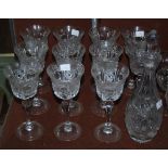 A set of eleven cut crystal wine glasses in star design, together with a matched decanter, 32cm