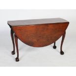 A George II mahogany dining table, circa 1740-60, the oval drop-leaf top on four cabriole legs