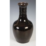 Chinese monochrome glazed black ground bottle vase, late 19th/ early 20th century, the neck with