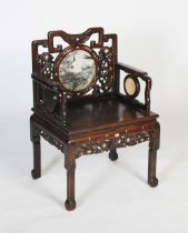 A Chinese carved darkwood and inlaid armchair, Qing Dynasty, the shaped back rail with two carved