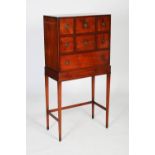 An early 20th century mahogany cabinet on stand, the cabinet of square form with two rows of short