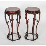 A pair of Chinese carved darkwood and burr elm stands, Qing Dynasty, the round burr elm tops over