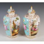 A pair of Dresden porcelain turquoise ground urns and covers, decorated with panels of figures