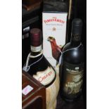 A bottle of Famous Grouse Scotch whisky 70cl, together with two bottles of red wine.