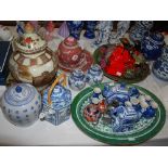 A large group of Asian ceramic items, including a large Chinese famille verte ashet, a celadon bowl,