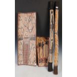 Two Australian Aboriginal bark paintings and two didgeridoos, 20th century, one bark painting of two