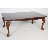 Large mahogany extending dining table, the rectangular top with rounded corners with one extending