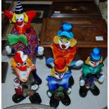 Group of five Murano glass clown figures, with stylised faces and large bow decoration in primary