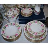 A Royal Worcester Royal Garden Elgar pattern dinner service, decorated with a frieze of white and
