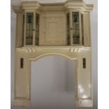 A Scottish Glasgow School Arts & Crafts painted wood, leaded glass and metal mounted fire surround
