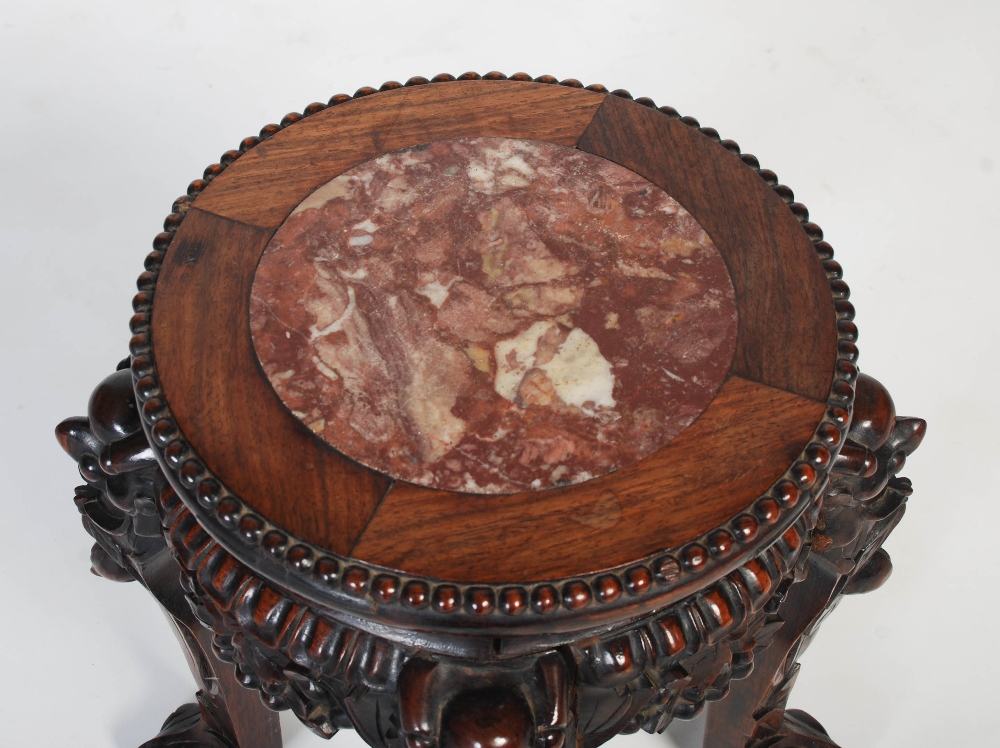 A Chinese carved darkwood stand, Qing Dynasty, the round top inset with marble, over carved and - Image 2 of 5