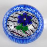A limited edition Perthshire paperweight, centred with a deep blue six petal gentian flower on a