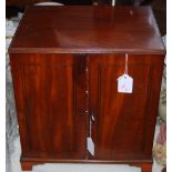 An early 20th century mahogany collectors cabinet, with two front doors opening to reveal a series