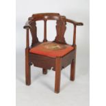 A 19th century mahogany corner chair, with serpentine curving back rail and serpentine splats on