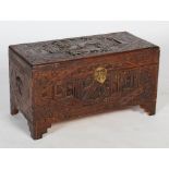 A 20th century Chinese carved darkwood coffier / trunk, of rectangular form with rounded corners,