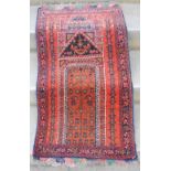 Persian prayer mat, the madder ground with mihrab shaped panel enclosing stylised flowers within