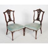 Pair of Edwardian mahogany salon chairs, the backs with carved rails and pierced splats with