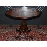 A 19th Century rosewood and marquetry inlaid centre table, the shaped circular top inlaid with