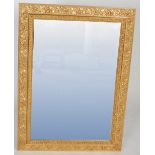 Three modern wall mirrors including a gilt framed example with scrolling foliate border, a silver