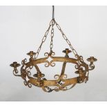 Gilt wrought-iron six bar chandelier, of circular form with scrolling details and scrolling arms