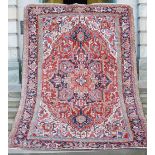 An early 20th century Heriz carpet, North-West Persia, the deep red field around hooked and