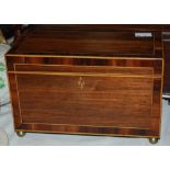 A 19th century strung rosewood tea caddy, the interior with two compartments on four brass bun feet,