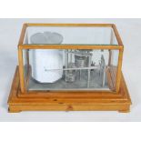 A 20th century Negretti and Zambra barograph, in a bevelled glass glazed oak case with a lower