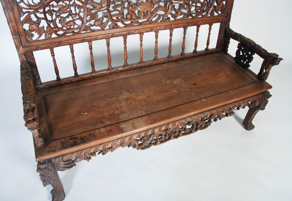 A Chinese carved darkwood bench, Qing Dynasty, the back richly carved in relief with two dragons - Image 5 of 8