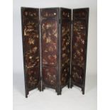 A Chinese lacquer and hardstone inlaid four-fold screen, late 19th/ early 20th century, each with an
