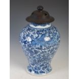 A Chinese porcelain blue and white jar and wooden cover, Qing Dynasty, decorated with phoenix, peony