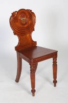 A 19th century mahogany armorial hall chair, the shaped back with gadrooned swag mouldings, the wood