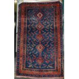An early 20th century Persian Caucasian rug, indigo field of geometrical motifs with a single column