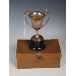 Late 19th/ early 20th century white metal two-handled trophy, in fitted case with ebonised base.