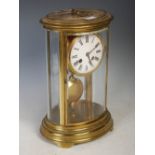 Late 19th / early 20th century French oval four-glass brass clock, the oval case with four