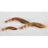 Three assorted early 20th century yellow metal and ruby set Kukri brooches, each stamped 18C,