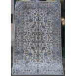 A Persian Kashan rug, the eau-de-nile field with design of scrolling indigo and cream floral
