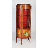 A 20th century French mahogany and gilt metal mounted vitrine, the central glazed door revealing two