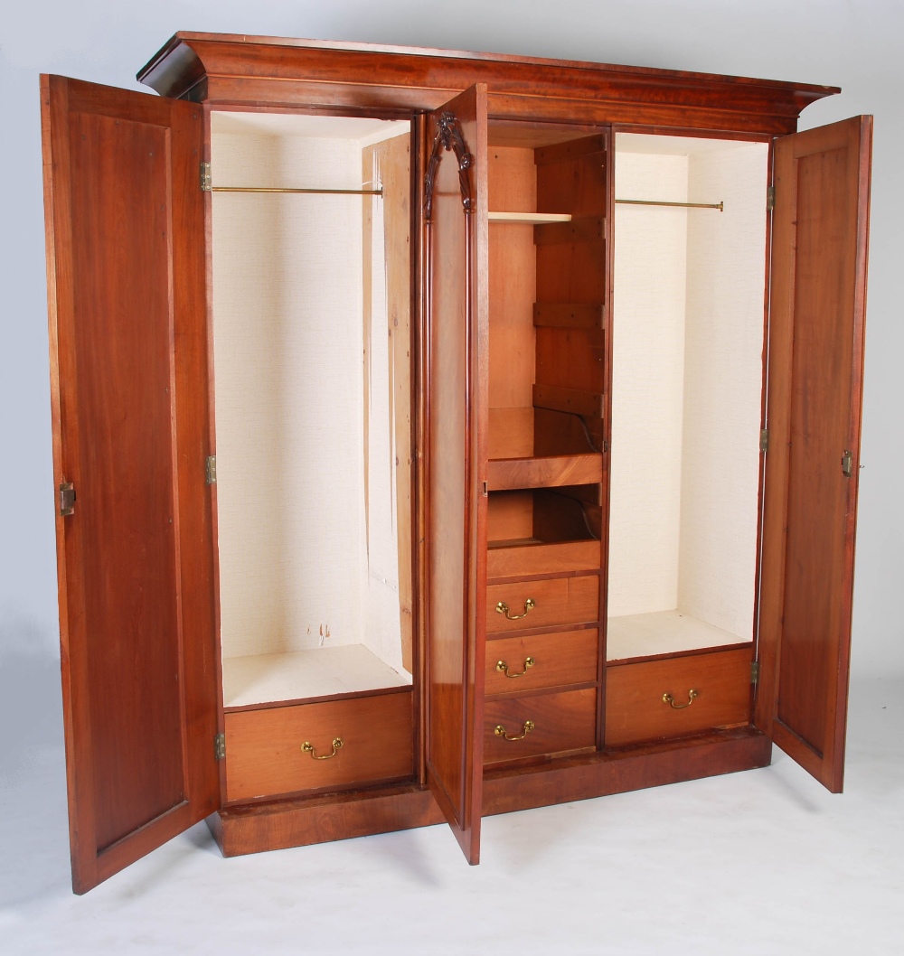 A late 19th century mahogany triple section wardrobe, with a rectangular cavetto pediment atop three - Image 4 of 6