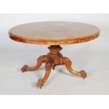 A burr walnut tilt-top centre table, the top of oval plain form on top of a carved single support